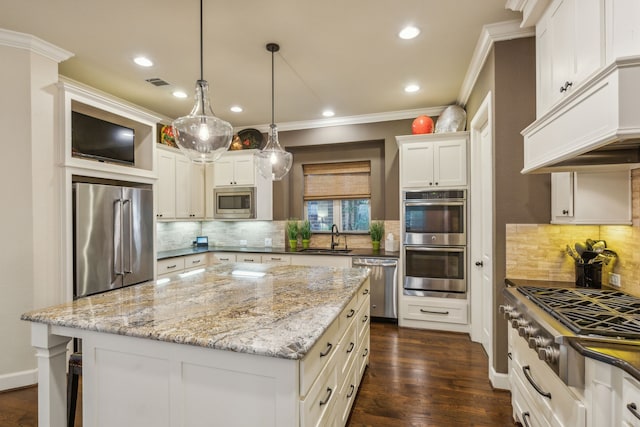 kitchen featuring white cabinets, a kitchen island, dark hardwood / wood-style flooring, stainless steel appliances, and sink