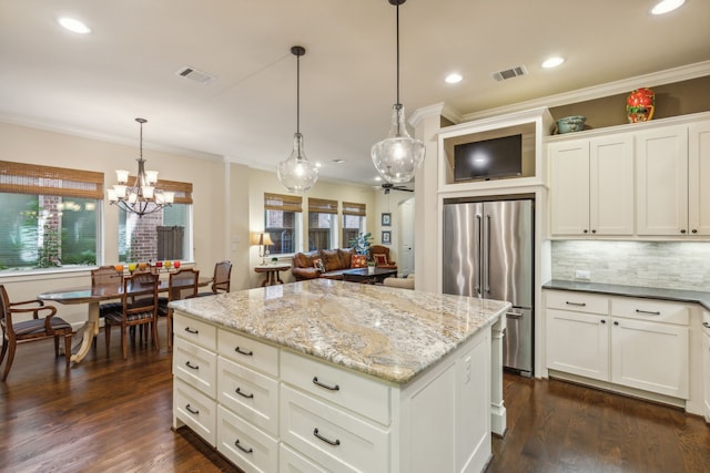 kitchen featuring pendant lighting, high end fridge, dark hardwood / wood-style flooring, and a wealth of natural light