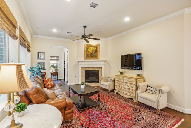 living room featuring ceiling fan, hardwood / wood-style flooring, and crown molding