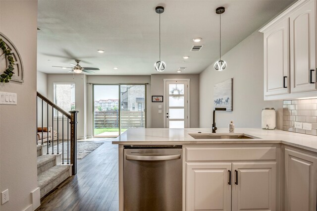 kitchen featuring dishwasher, dark hardwood / wood-style floors, decorative backsplash, sink, and white cabinets