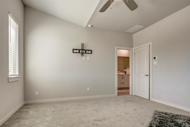 spare room featuring light carpet and ceiling fan