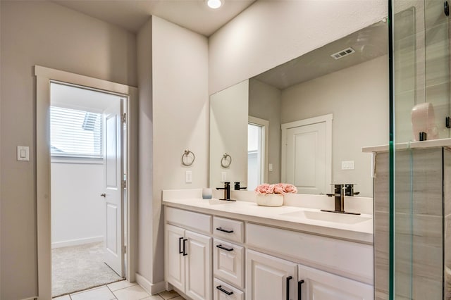 bathroom featuring tile patterned floors, vanity, and walk in shower