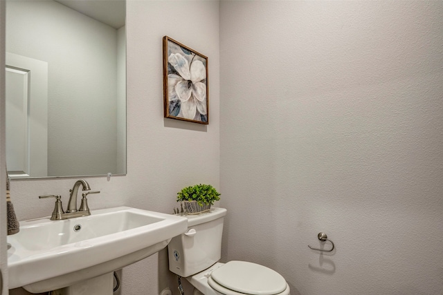 bathroom with toilet and sink