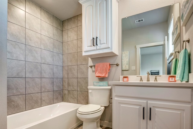 full bathroom with toilet, vanity, and tiled shower / bath