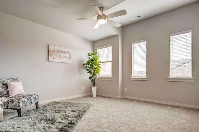 sitting room featuring ceiling fan and light carpet