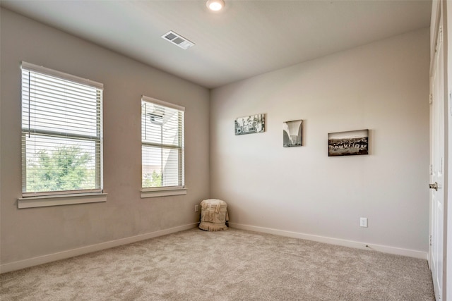 unfurnished room featuring light colored carpet