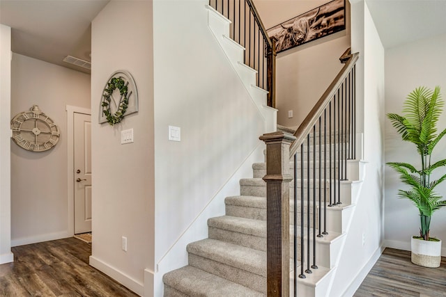 stairs featuring wood-type flooring