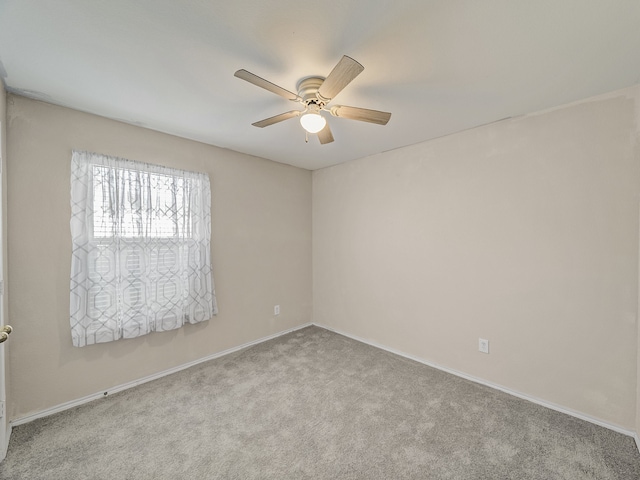 unfurnished room featuring ceiling fan and light colored carpet