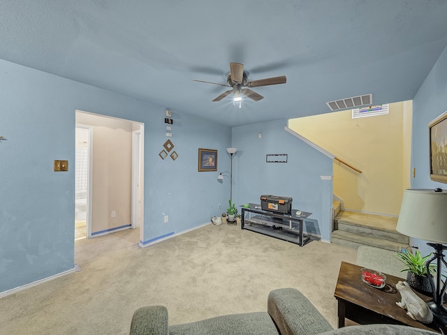 carpeted living room with ceiling fan