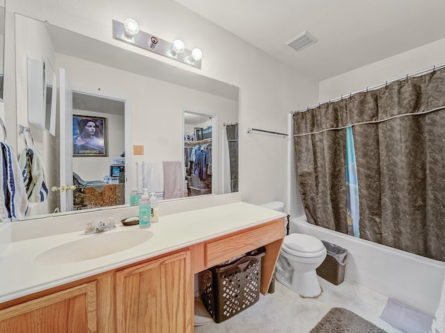 full bathroom featuring vanity, shower / tub combo, and toilet