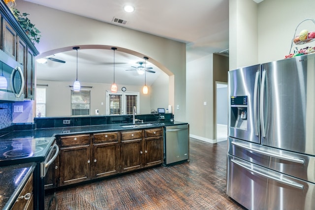 kitchen featuring dark brown cabinets, stainless steel appliances, hanging light fixtures, and sink