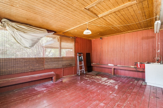 misc room with wooden walls, wood ceiling, and hardwood / wood-style floors