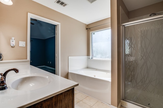 bathroom featuring independent shower and bath, tile patterned flooring, and vanity