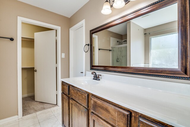 bathroom with vanity, tile patterned floors, and a shower with shower door