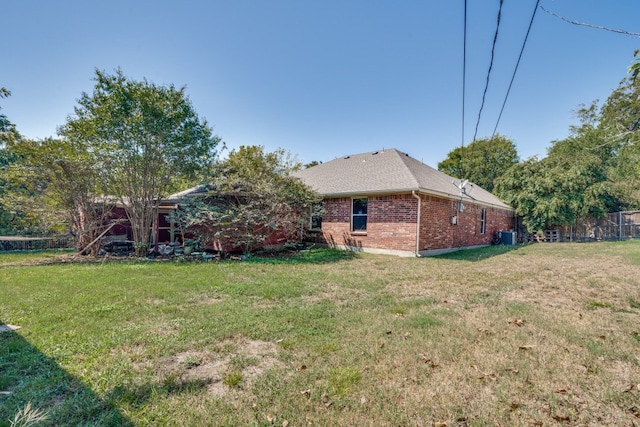 rear view of house featuring a yard