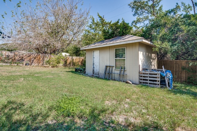 view of outbuilding featuring a lawn