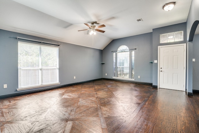 foyer with a healthy amount of sunlight, lofted ceiling, dark hardwood / wood-style floors, and ceiling fan