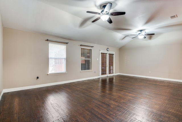 spare room with lofted ceiling, dark hardwood / wood-style flooring, and ceiling fan