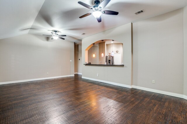 unfurnished living room featuring lofted ceiling, dark hardwood / wood-style flooring, and ceiling fan