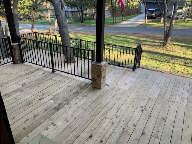 wooden deck featuring a yard