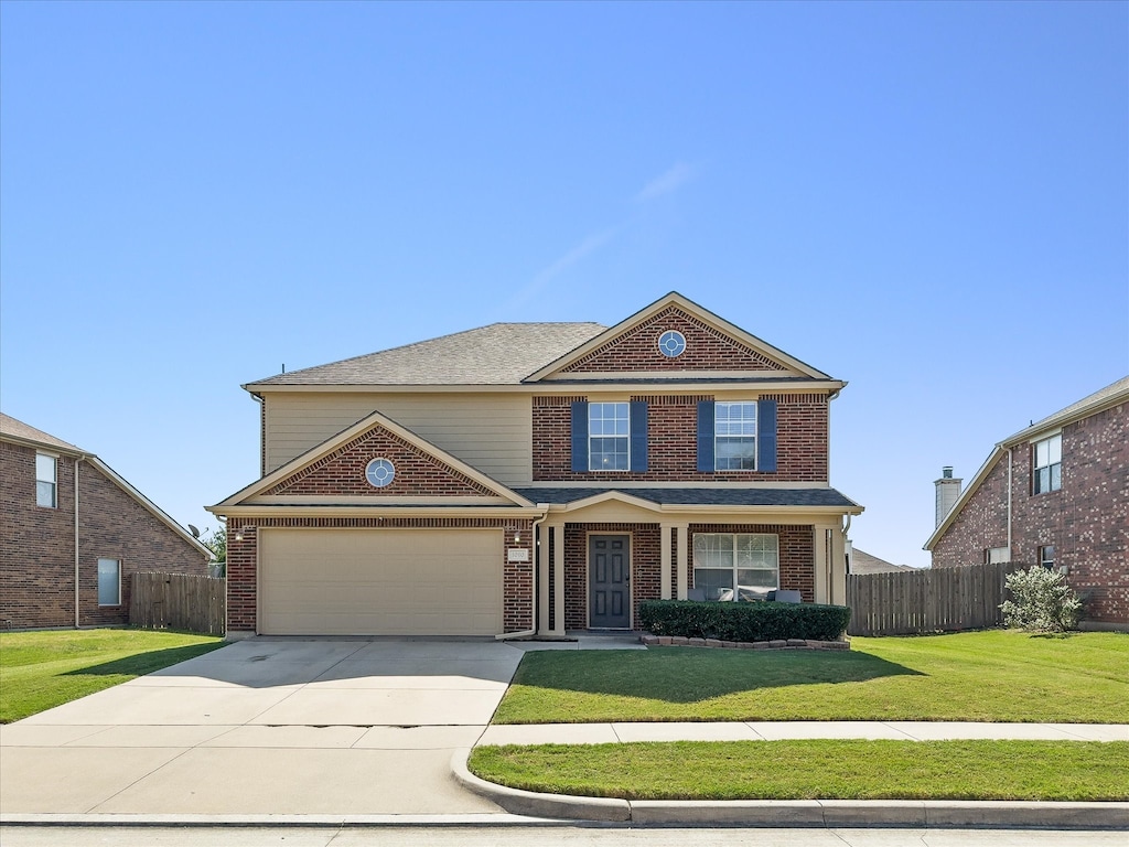 view of front of home featuring a garage and a front yard