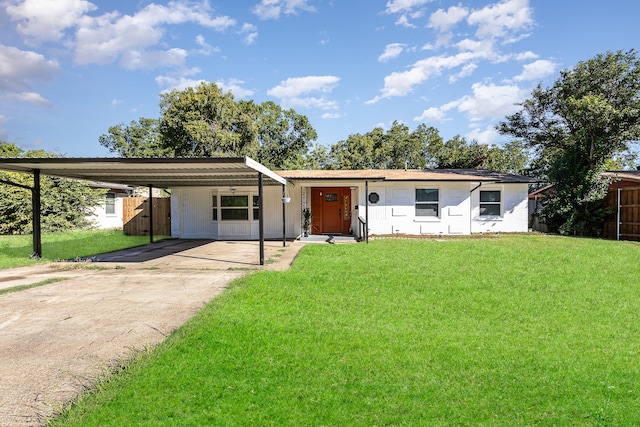 ranch-style house featuring a carport and a front yard