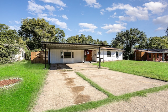 ranch-style house with a front yard and a carport