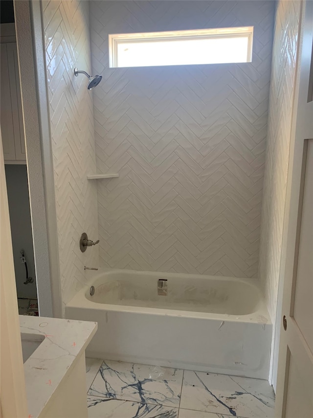 bathroom featuring vanity and tiled shower / bath