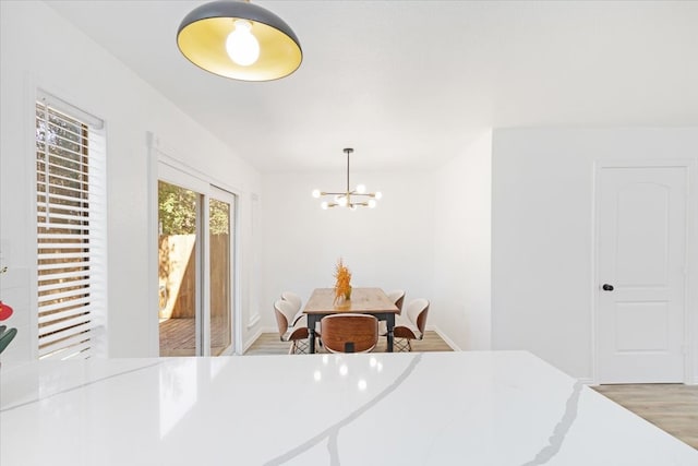 dining space featuring a chandelier and light hardwood / wood-style flooring