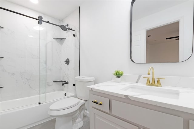 full bathroom with vanity, toilet, combined bath / shower with glass door, and ceiling fan