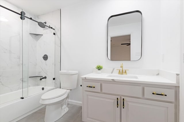 full bathroom featuring ceiling fan, tile patterned floors, bath / shower combo with glass door, toilet, and vanity