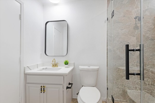 bathroom featuring vanity, toilet, and walk in shower