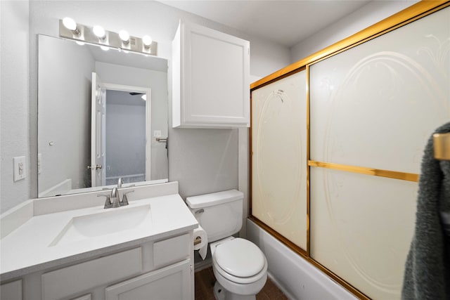 full bathroom featuring vanity, toilet, and combined bath / shower with glass door