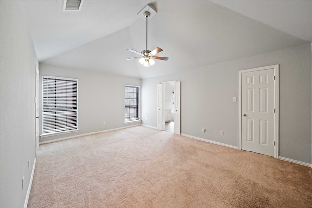 empty room featuring high vaulted ceiling, ceiling fan, and light colored carpet