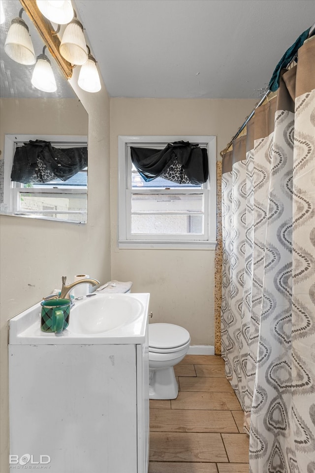 bathroom with vanity, a shower with curtain, hardwood / wood-style flooring, and toilet