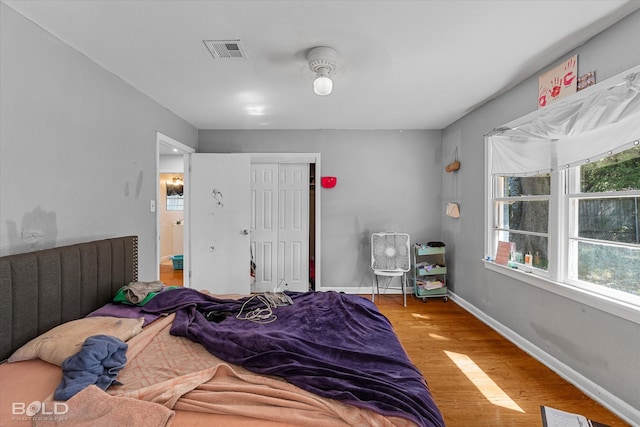 bedroom featuring a closet, ceiling fan, and hardwood / wood-style flooring