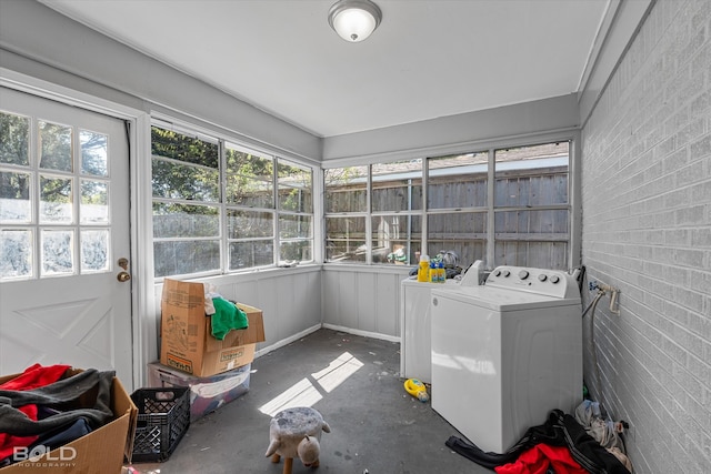 sunroom featuring plenty of natural light and washer and clothes dryer