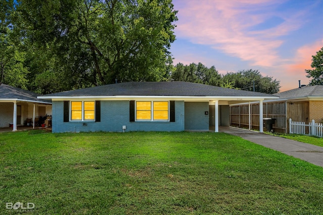 ranch-style home with a lawn