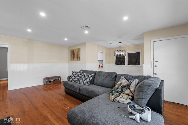 living room featuring an inviting chandelier and hardwood / wood-style flooring