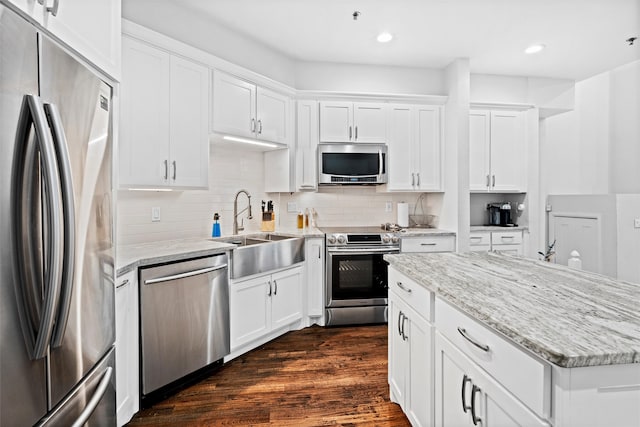 kitchen featuring sink, white cabinetry, stainless steel appliances, and dark wood-type flooring