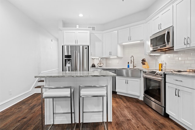 kitchen featuring dark hardwood / wood-style flooring, sink, white cabinets, and stainless steel appliances