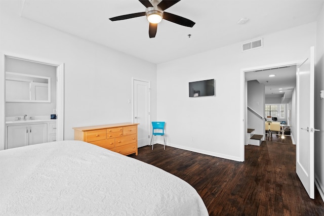 bedroom with ensuite bath, ceiling fan, dark wood-type flooring, and sink