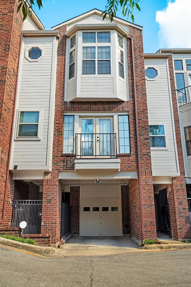 view of front of home featuring a garage and a balcony