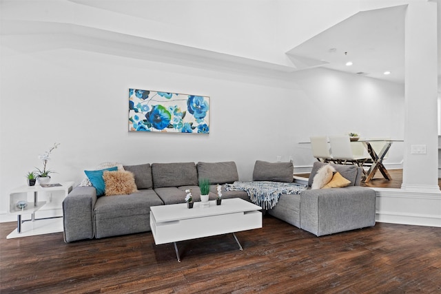 living room featuring ornate columns and dark hardwood / wood-style floors