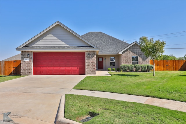 single story home featuring a garage and a front yard