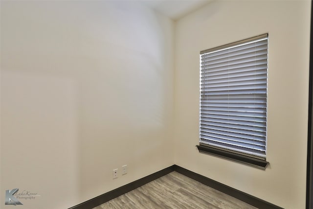 empty room with light hardwood / wood-style flooring