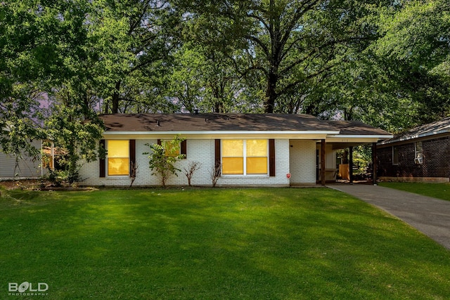 ranch-style house featuring a front yard and a carport