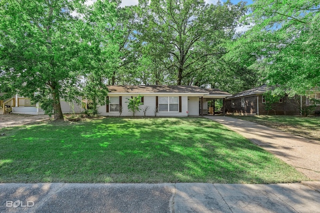 single story home with a front lawn and a carport