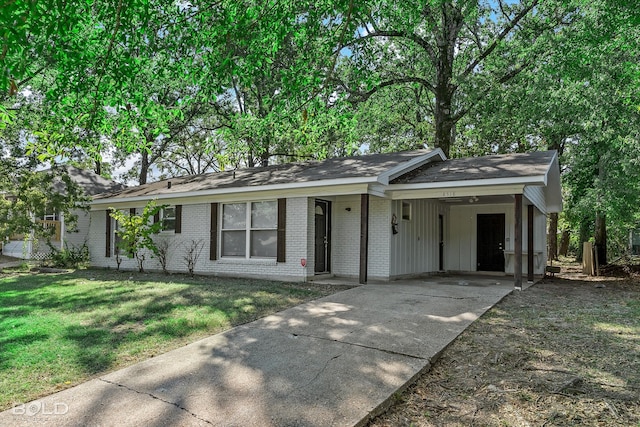 ranch-style home with a carport and a front yard