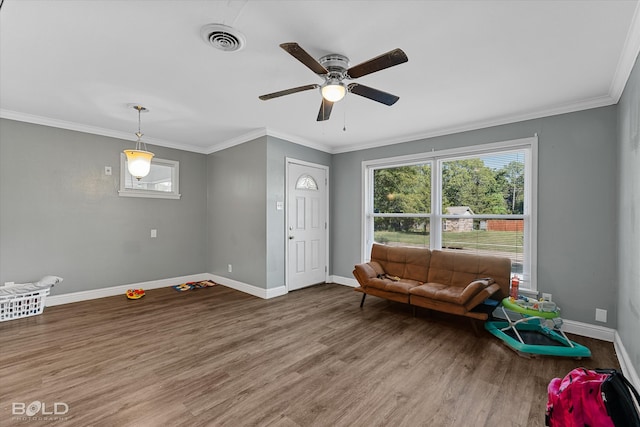 interior space with wood-type flooring, crown molding, and ceiling fan